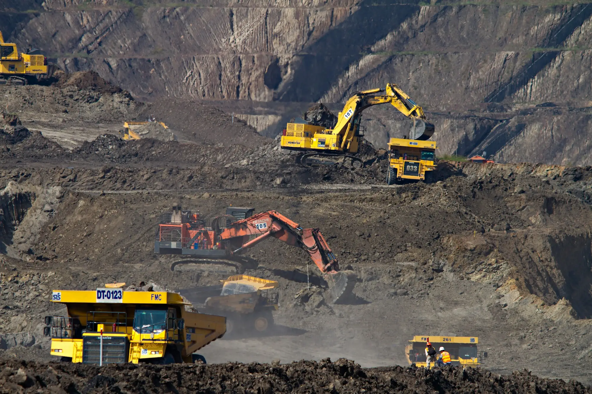 Excavators loading haul trucks on an active site